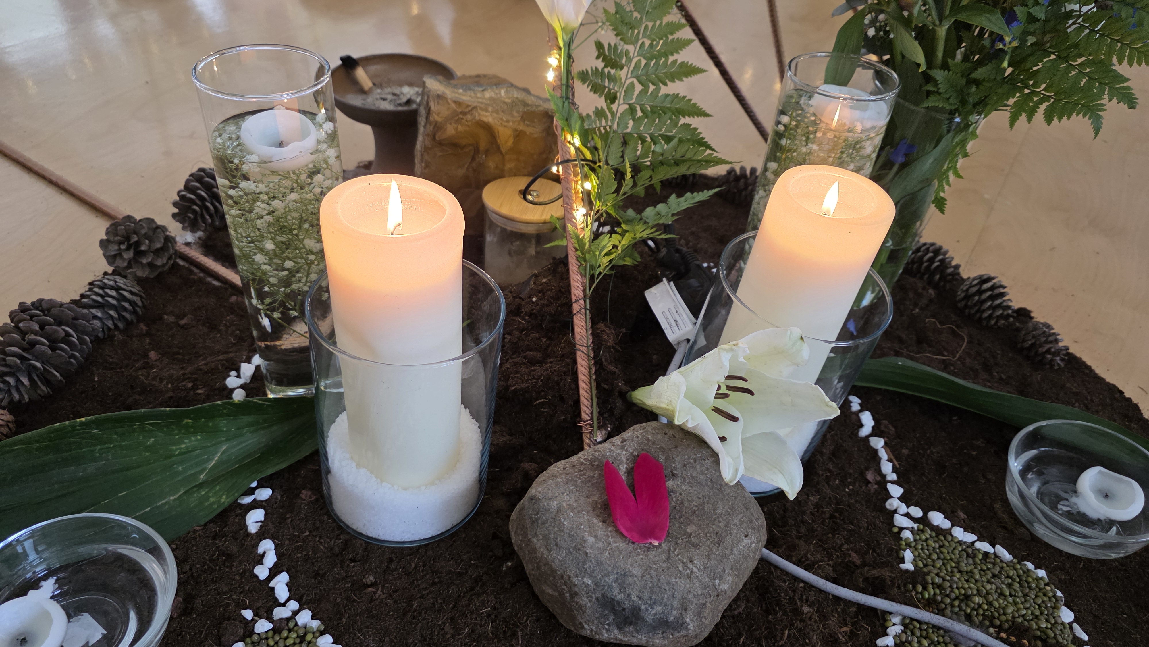 Sacred ceremony space — copper star with earth altar and candlelight